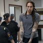 WNBA star and two-time Olympic gold medalist Brittney Griner is escorted from a courtroom after a hearing in Khimki just outside Moscow, Russia, on Aug. 4, 2022. The jailed American basketball star has been moved to a penal colony in Russia, her legal team said Wednesday, Nov. 9, 2022.(AP Photo/Alexander Zemlianichenko, File) **FILE**