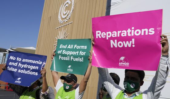 A group of demonstrators participate in an event protesting the use of fossil fuels and calling for reparations at the COP27 U.N. Climate Summit, Wednesday, Nov. 9, 2022, in Sharm el-Sheikh, Egypt. (AP Photo/Peter Dejong)