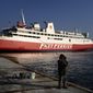 A man fishes as a ferry is docked during a 24-hour strike at the port of Rafina, east of Athens, Greece, Wednesday, Nov. 9, 2022. A 24-hour general strike called by Greece&#39;s private and public sector unions is set to shut down most services around the country Wednesday. (AP Photo/Thanassis Stavrakis)