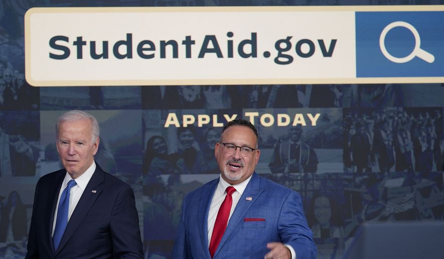 President Joe Biden answers questions with Education Secretary Miguel Cardona as they leave an event about the student debt relief portal beta test in the South Court Auditorium on the White House complex in Washington, Monday, Oct. 17, 2022. (AP Photo/Susan Walsh) ** FILE **
