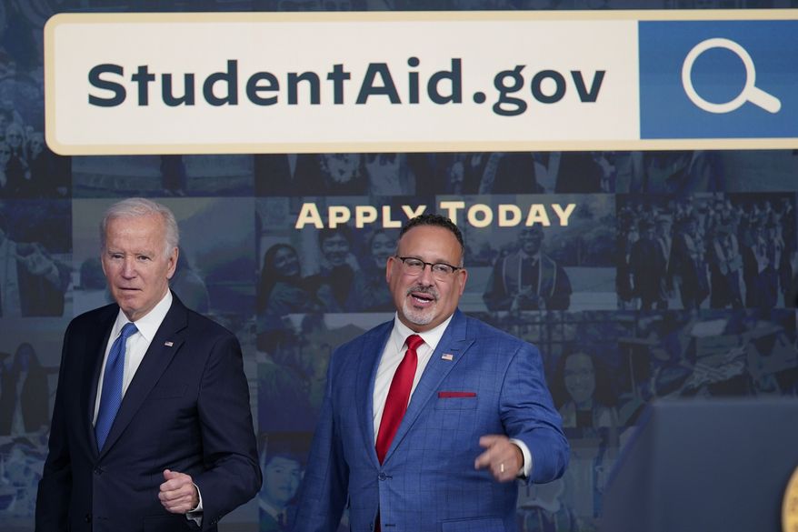 President Joe Biden answers questions with Education Secretary Miguel Cardona as they leave an event about the student debt relief portal beta test in the South Court Auditorium on the White House complex in Washington, Monday, Oct. 17, 2022. (AP Photo/Susan Walsh) ** FILE **
