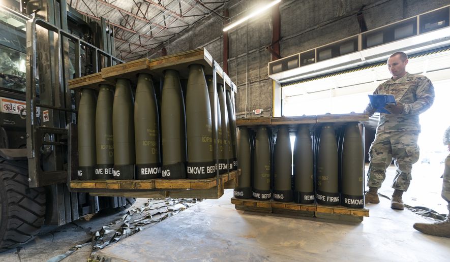 U.S. Air Force Staff Sgt. Cody Brown, right, with the 436th Aerial Port Squadron, checks pallets of 155 mm shells ultimately bound for Ukraine, April 29, 2022, at Dover Air Force Base, Del. Officials say the U.S. will send $400 million more in military aid to Ukraine amid concerns financial assistance for the war against Russia could decline if Republicans take control of Congress. (AP Photo/Alex Brandon, File)