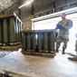U.S. Air Force Staff Sgt. Cody Brown, right, with the 436th Aerial Port Squadron, checks pallets of 155 mm shells ultimately bound for Ukraine, April 29, 2022, at Dover Air Force Base, Del. Officials say the U.S. will send $400 million more in military aid to Ukraine amid concerns financial assistance for the war against Russia could decline if Republicans take control of Congress. (AP Photo/Alex Brandon, File)