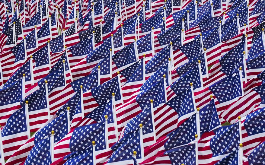 United States flags wave in the wind at the Field of Honor at San Gabriel Park in Georgetown, Texas, on Wednesday Nov. 9, 2022. (Jay Janner/Austin American-Statesman via AP)