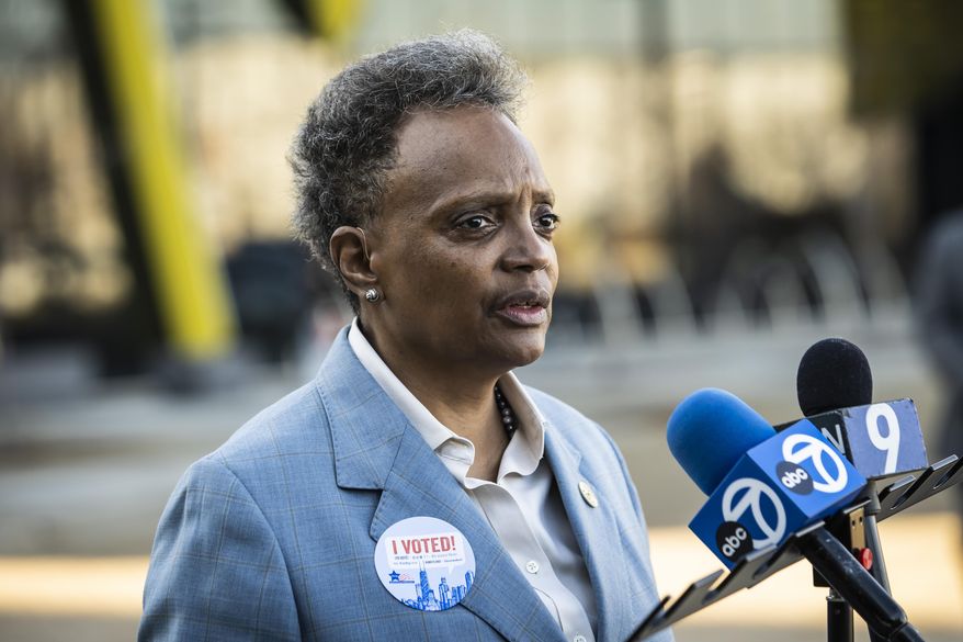 Mayor Lori Lightfoot talks to reporters after she and  Amy Eshleman early voted in the Nov. 8 midterm election at NEIU El Centro Thursday, Nov. 3, 2022 in Chicago.   (Ashlee Rezin /Chicago Sun-Times via AP)