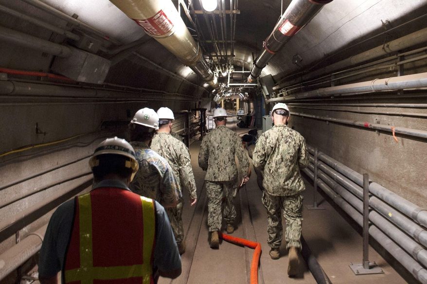 In this file photo provided by the U.S. Navy, Rear Adm. John Korka, Commander, Naval Facilities Engineering Systems Command (NAVFAC), and Chief of Civil Engineers, leads Navy and civilian water quality recovery experts through the tunnels of the Red Hill Bulk Fuel Storage Facility, near Pearl Harbor, Hawaii, on Dec. 23, 2021. More than two dozen families have joined a lawsuit accusing the U.S. Navy of making them sick from jet fuel that leaked into the tap water in their Hawaii homes. There are now more than 100 people in an amended lawsuit filed Thursday, Nov. 10, 2022, that also accuses the Navy of destroying more than 1,000 water samples collected from affected homes. (Mass Communication Specialist 1st Class Luke McCall/U.S. Navy via AP, File)