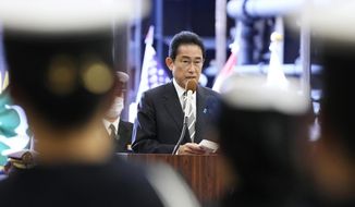 Japanese Prime Minister Fumio Kishida delivers a speech on the Maritime Self Defense Force&#39;s helicopter carrier JS Izumo during an international fleet review in Sagami Bay, southwest of Tokyo on Nov. 6, 2022. Japan and the United States began a major joint military exercise Thursday, Nov. 10, 2022 in southern Japan as the allies aim to step up readiness in the face of China’s increasing assertiveness and North Korea’s intensifying missile launches. (Kyodo News via AP, File)