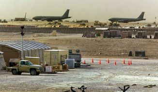 American military planes and support facilities are seen at the Al Udeid Air Base outside Doha, Qatar, March 17, 2002. Qatar will be on the world stage like it never has before as the small, energy-rich nations hosts the 2022 FIFA World Cup beginning this November. (AP Photo/J. Scott Applewhite, File)