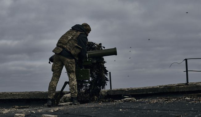 A Ukrainian soldier prepares to fire a anti-tank rocket in Bakhmut, Donetsk region, Ukraine, Thursday, Nov. 10, 2022. (AP Photo/LIBKOS)