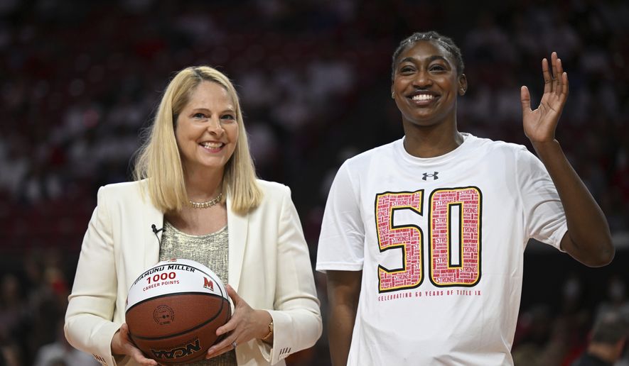 Maryland&#39;s Diamond Miller is presented a basketball by coach Brenda Frese in honor of her 1000 career points scored before an NCAA college basketball game, Friday, Nov. 11, 2022, in College Park, Md. (AP Photo/Gail Burton) **FILE**