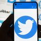 The Twitter logo is seen on a cell phone, Friday, Oct. 14, 2022, in Boston.  The “official” designation for major corporate accounts on Twitter appeared, vanished, and depending on the account, appeared or vanished again and some companies took to the social media platform to warn of imposters.  (AP Photo/Michael Dwyer, File)