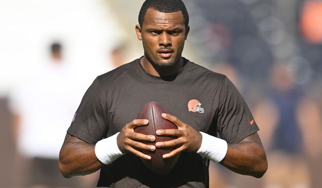 Cleveland Browns quarterback Deshaun Watson stands on the field before an NFL preseason football game against the Chicago Bears, on Aug. 27, 2022, in Cleveland. Watson can begin practicing on Monday, Nov. 14, 2022,  as part of his agreement with the NFL on an 11-game suspension after being accused of sexual misconduct by two dozen women when he played for Houston. (AP Photo/David Richard, File)