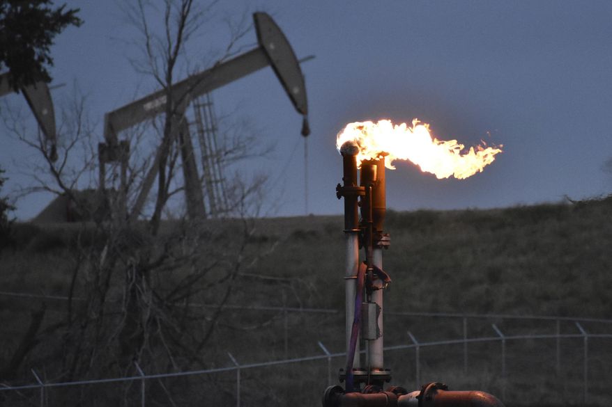 A flare to burn methane from oil production is seen on a well pad near Watford City, North Dakota, Aug. 26, 2021. The Biden administration is ramping up efforts to reduce methane emissions, targeting the oil and gas industry for its role in global warming even as President Joe Biden has pressed energy producers for more oil drilling to lower prices at the gasoline pump. Biden was set to announce a supplemental rule Friday, Nov. 11, 2022, cracking down on emissions of methane as he attends a global climate conference in Egypt. (AP Photo/Matthew Brown, File)