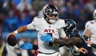 Atlanta Falcons quarterback Marcus Mariota is sacked by Carolina Panthers defensive end Marquis Haynes Sr. during the second half of an NFL football game on Thursday, Nov. 10, 2022, in Charlotte, N.C. (AP Photo/Jacob Kupferman)