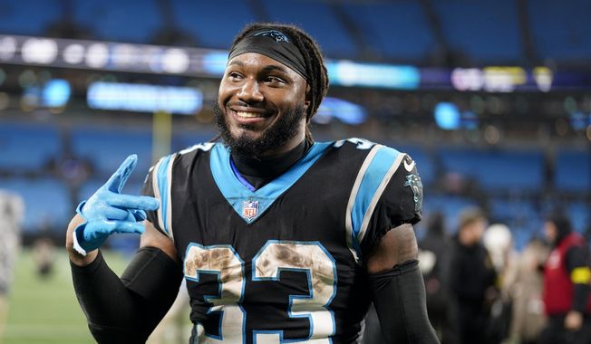 Carolina Panthers running back D&#x27;Onta Foreman smiles after their win against the Atlanta Falcons in an NFL football game on Thursday, Nov. 10, 2022, in Charlotte, N.C. (AP Photo/Jacob Kupferman)