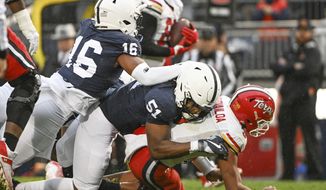 Penn State defenders Ji&#39;Ayir Brown (16) and Hakeem Beamon (51 sack Maryland quarterback Taulia Tagovailoa (3) during the first half of an NCAA college football game, Saturday, Nov. 12, 2022, in State College, Pa. (AP Photo/Barry Reeger) **FILE**