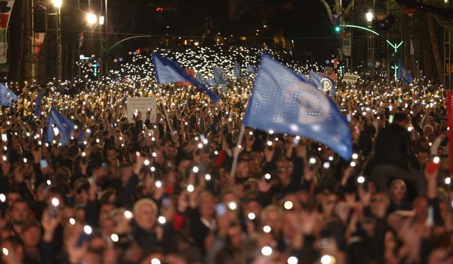 Protesters raise their mobile phones flashlights during an anti-government rally in Tirana, Albania, on Saturday, Nov. 12, 2022. Thousands of Albanian opposition supporters protested against the center-left government&#x27;s alleged corruption and this year&#x27;s significant rise of prices due to the cost-of-living crisis. (AP Photo/Franc Zhurda)