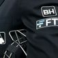 FILE - The FTX logo appears on a home plate umpire&#x27;s jacket at a baseball game with the Minnesota Twins on Sept. 27, 2022, in Minneapolis. Collapsed cryptocurrency trading firm FTX confirmed there was “unauthorized access” to its accounts, hours after the company filed for Chapter 11 bankruptcy protection Friday, Nov. 11, 2022.  (AP Photo/Bruce Kluckhohn, File)