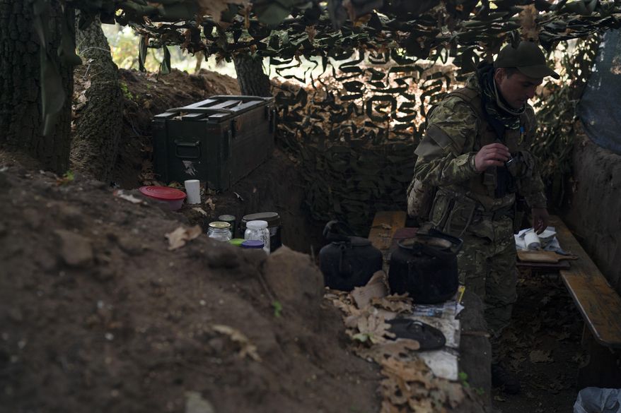 A Ukrainian serviceman checks the trenches dug by Russian soldiers in a retaken area in Kherson region, Ukraine, Oct. 12, 2022. Russia relinquished its final foothold in a major city in southern Ukraine on Friday Nov. 11, 2022, clearing the way for victorious Ukrainian forces to reclaim the country’s only Russian-held provincial capital that could act as a springboard for further advances into occupied territory. (AP Photo/Leo Correa, File)