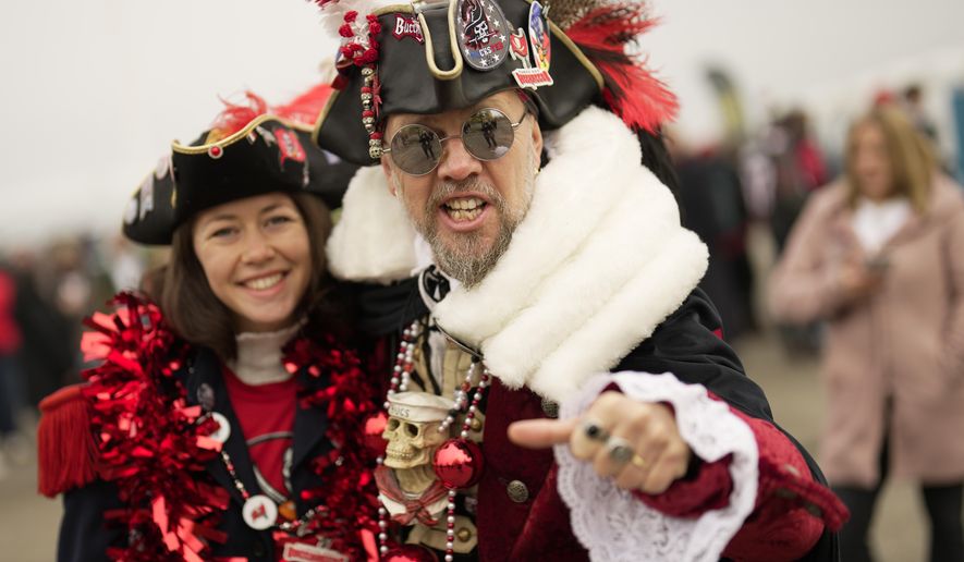 Fans of the Buccaneers pose for a photo as they arrives for a NFL match between Tampa Bay Buccaneers and Seattle Seahawks at the Allianz Arena in Munich, Germany, Sunday, Nov. 13, 2022. (AP Photo/Markus Schreiber)