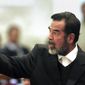 Former Iraqi president Saddam Hussein gestures during his trial in Baghdad, Iraq, Jan. 29, 2006. Lawyer Bushra al-Khalil said Sunday, Nov. 13, 2022 that her client Abdullah Yasser Sabaawi, great-nephew of the late Iraqi leader Saddam Hussein, has no links with the Islamic State group but was sent back to Iraq as part of a political deal with Lebanese authorities. (AP Photo/Darko Bandic, File)