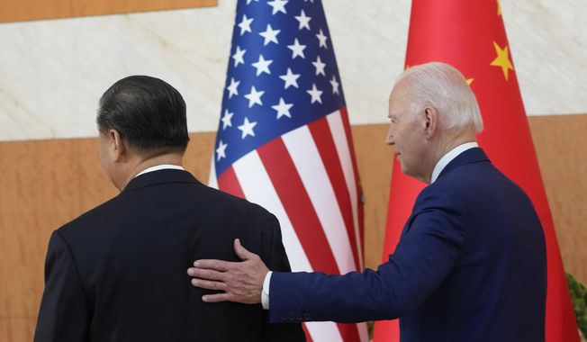 U.S. President Joe Biden, right, walks with Chinese President Xi Jinping before their meeting on the sidelines of the G-20 summit meeting, Monday, Nov. 14, 2022, in Nusa Dua, in Bali, Indonesia. (AP Photo/Alex Brandon)
