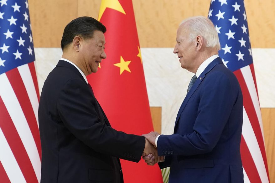 U.S. President Joe Biden, right, and Chinese President Xi Jinping shake hands before their meeting on the sidelines of the G20 summit meeting, Monday, Nov. 14, 2022, in Nusa Dua, in Bali, Indonesia. (AP Photo/Alex Brandon)