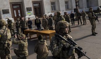 Ukrainian President Volodymyr Zelenskyy guarded by soldiers, gives a speech in Kherson, southern Ukraine, Monday, Nov. 14, 2022. Ukraine&#39;s retaking of Kherson was a significant setback for the Kremlin and it came some six weeks after Russian President Vladimir Putin annexed the Kherson region and three other provinces in southern and eastern Ukraine — in breach of international law — and declared them Russian territory. (AP Photo/Bernat Armangue)