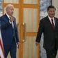 U.S. President Joe Biden, left, arrives with Chinese President Xi Jinping for a meeting on the sidelines of the G20 summit meeting, Monday, Nov. 14, 2022, in Bali, Indonesia. (AP Photo/Alex Brandon)