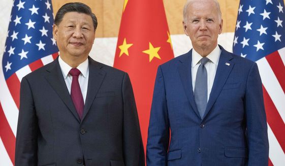 U.S. President Joe Biden, right, stands with Chinese President Xi Jinping before a meeting on the sidelines of the G20 summit meeting, Monday, Nov. 14, 2022, in Bali, Indonesia. (AP Photo/Alex Brandon)