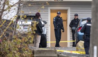 Officers investigate a homicide at an apartment complex south of the University of Idaho campus on Sunday, Nov. 13, 2022. Four people were found dead on King Road near the campus, according to a city of Moscow news release issued Sunday afternoon. (Zach Wilkinson/The Moscow-Pullman Daily News via AP)