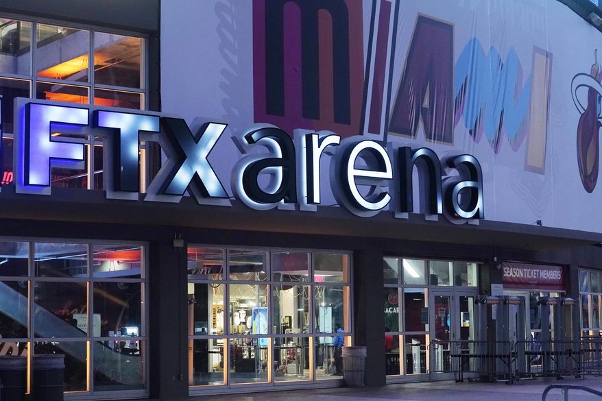 Signage for the FTX Arena, where the Miami Heat basketball team plays, is illuminated on Saturday, Nov. 12, 2022, in Miami. The rapid collapse of cryptocurrency exchange FTX into bankruptcy last week has also shaken the world of philanthropy, due to the donations and influence of FTX founder Sam Bankman-Fried in the “effective altruism” movement. (AP Photo/Marta Lavandier, File)