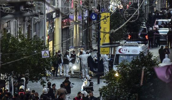Forensic experts collect a dead body after an explosion on Istanbul&#39;s popular pedestrian Istiklal Avenue Sunday, Istanbul, Sunday, Nov. 13, 2022. (Ismail Coskun/IHA via AP, File)