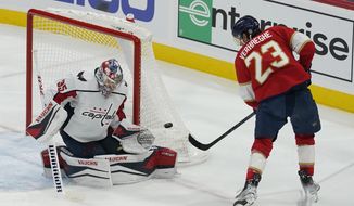 Florida Panthers center Carter Verhaeghe (23) makes a shot on goal as Washington Capitals goaltender Darcy Kuemper (35) defends during the second period of an NHL hockey game, Tuesday, Nov. 15, 2022, in Sunrise, Fla. (AP Photo/Marta Lavandier)