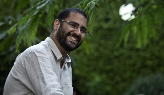 In this Monday, Sept. 22, 2014 photo, Egypt&#39;s most prominent activist Alaa Abdel-Fattah greets people prior to a conference held at the American University in Cairo, near Tahrir Square, Egypt. The family of the imprisoned Egyptian activist  says they received a letter from him on Tuesday, Nov. 15, 2022,  saying he has ended his hunger strike. The family said in a statement that Abdel-Fattah&#39;s mother, Laila Soueif, received a short note in her son’s handwriting via prison authorities. The letter is dated Monday. In it, he asks her to come for monthly visit to him in prison on Thursday.   (AP Photo/Nariman El-Mofty, File)