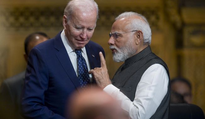 U.S. President Joe Biden, left, talks with India&#x27;s Prime Minister Narendra Modi during the G20 Summit in Nusa Dua, Bali, Indonesia, Tuesday Nov. 15, 2022. (Bay Ismoyo/Pool Photo via AP)
