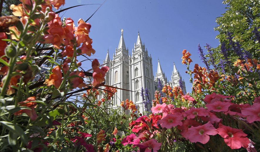 Flowers bloom in front of the Salt Lake Temple, at Temple Square, on Aug. 4, 2015, in Salt Lake City. The Church of Jesus Christ of Latter-day Saints on Tuesday, Nov. 15, 2022, came out in support of The Respect for Marriage Act under consideration in Congress after years of opposing recognition of same-sex marriage. (AP Photo/Rick Bowmer, File)