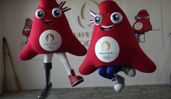 FILE - Mascots of the 2024 Paris Olympic Games, right, and Paralympics Games, a Phrygian cap, jump during a preview in Saint Denis, outside Paris, on Thursday, Nov. 10, 2022.  Izzy, the much-hated blob that represented the 1996 Atlanta Games has been supplanted by the mascot for the Paris Olympics — a Phrygian cap. (AP Photo/Christophe Ena, File)
