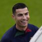 Cristiano Ronaldo smiles as he arrives for a Portugal soccer team training session in Oeiras, outside Lisbon, Monday, Nov. 14, 2022. Portugal will play Nigeria Thursday in a friendly match in Lisbon before departing to Qatar on Friday for the World Cup. (AP Photo/Armando Franca) **FILE**