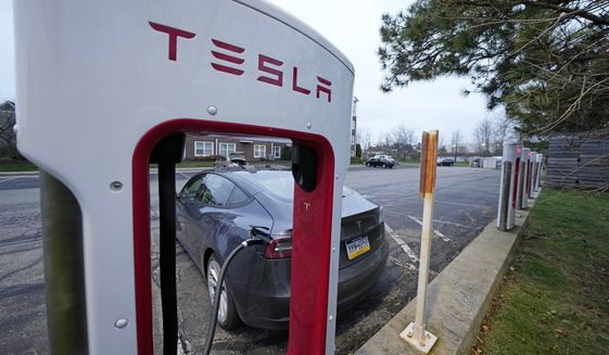 A Tesla sedan gets a charge at a Tesla Supercharging station in Cranberry, Pa, Wednesday, Nov. 16, 2022. (AP Photo/Gene J. Puskar)