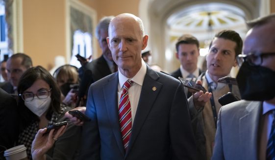 Sen. Rick Scott, R-Fla., who led the Senate Republican campaign arm this year, is surrounded by reporters as he arrives at the historic Old Senate Chamber where he is mounting a long-shot bid to unseat Senate Republican leader Mitch McConnell, at the Capitol in Washington, Wednesday, Nov. 16, 2022. (AP Photo/J. Scott Applewhite)