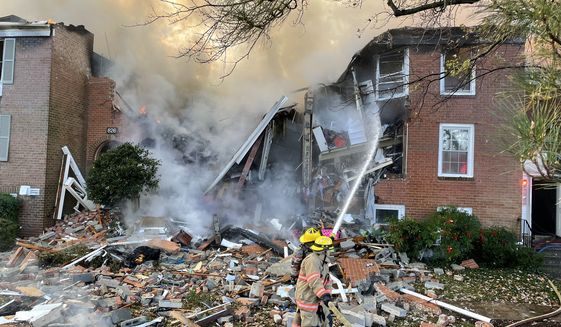 Crews with Montgomery County Fire &amp; Rescue put out remnants of a fire after an explosion rocked a Gaithersburg condo building Wednesday morning. (Courtesy: Pete Piringer/Montgomery County Fire &amp; Rescue)