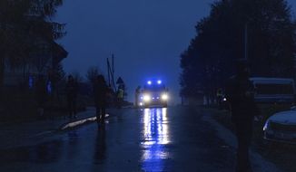 A police vehicle drives towards the scene of a blast in Przewodow, Poland, Wednesday, Nov. 16, 2022. Poland said Wednesday that a Russian-made missile fell in the country’s east, though U.S. President Joe Biden said it was “unlikely” it was fired from Russia. (AP Photo/Evgeniy Maloletka)