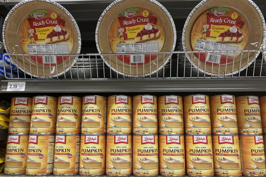 Canned pumpkin and graham cracker shell crusts are displayed at a Publix Supermarket, Tuesday, Nov. 16, 2021, in North Miami, Fla. Americans are bracing for a costly Thanksgiving this year, with double-digit percent increases in the price of turkey, potatoes, stuffing, canned pumpkin and other staples. (AP Photo/Marta Lavandier, File)