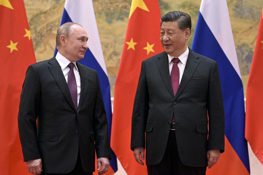 Chinese President Xi Jinping, right, and Russian President Vladimir Putin talk to each other during their meeting in Beijing, Friday, Feb. 4, 2022. The two leaders used the occasion of the Winter Olympics in Beijing to hold a summit and show solidarity. (Alexei Druzhinin, Sputnik, Kremlin Pool Photo via AP, File)
