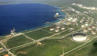 The Bullenbaai oil terminal sits along the coast of the Dutch Caribbean island of Curacao near Willemstad, Dec. 24, 2016. The terminal is at the center of an effort by Venezuela to get around U.S. sanctions, the Associated Press has learned. (AP Photo/Dick Drayer)
