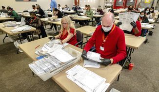 Election workers tabulate ballots for the midterm election at the Riverside County Registrar-Voter in Riverside, Calif., on Thursday, Nov. 10, 2022. (Watchara Phomicinda/The Orange County Register via AP)