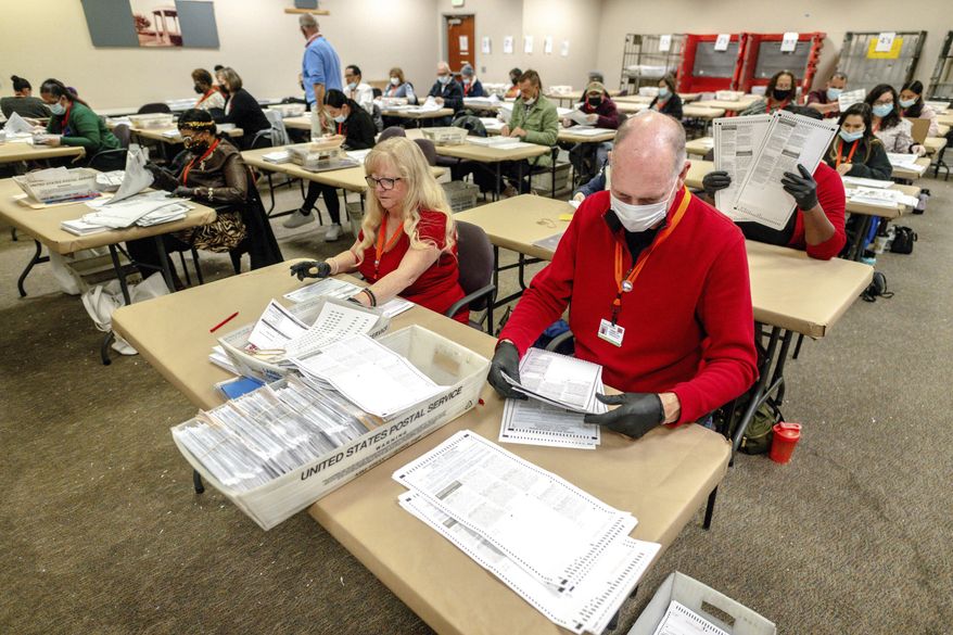 Election workers tabulate ballots for the midterm election at the Riverside County Registrar-Voter in Riverside, Calif., on Thursday, Nov. 10, 2022. (Watchara Phomicinda/The Orange County Register via AP)