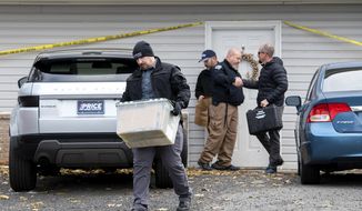 Officers investigate the deaths of four University of Idaho students at an apartment complex south of campus on Monday, Nov. 14, 2022, in Moscow, Idaho. The Moscow Police Department has labeled the deaths as “homicides” but maintains there is not an active risk to the community.  (Zach Wilkinson/The Moscow-Pullman Daily News via AP)
