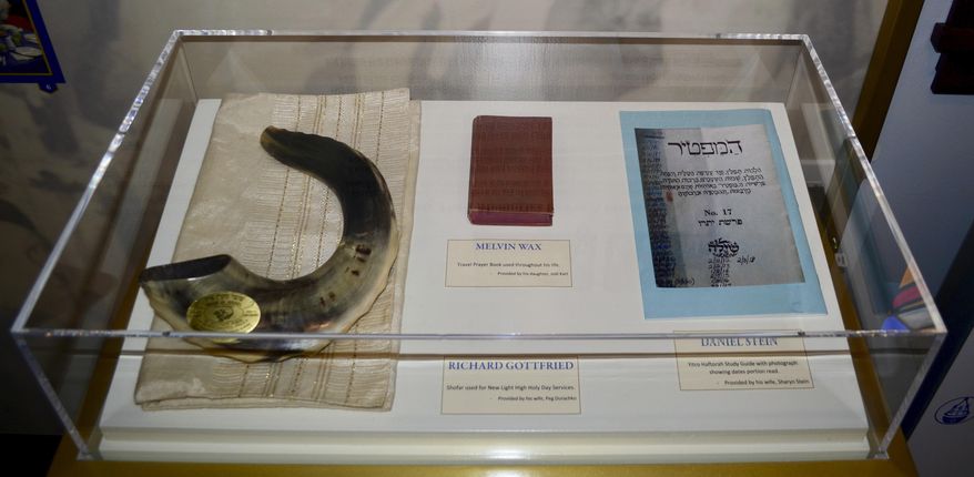 Artifacts are displayed on Sunday, Nov. 13, 2022, at the New Light Memorial Chapel in Shaler, Pa., including religious items used by the three members of New Light Congregation who were among the 11 victims of the Oct. 27, 2018, massacre at Pittsburgh’s Tree of Life synagogue building. They include a shofar used by Richard Gottfried for High Holy Day services, a travel prayer book used by Melvin Wax and a biblical study guide used by Daniel Stein. The chapel was dedicated Nov. 13. (AP Photo/Peter Smith)